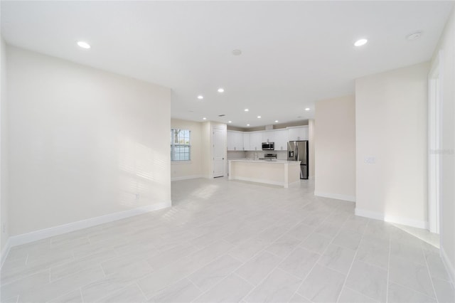 unfurnished living room featuring light tile patterned floors