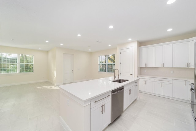 kitchen featuring sink, dishwasher, white cabinetry, an island with sink, and decorative backsplash