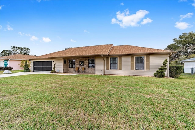 ranch-style house featuring a garage and a front lawn