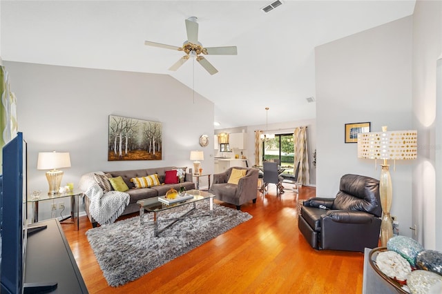 living room featuring wood-type flooring, lofted ceiling, and ceiling fan