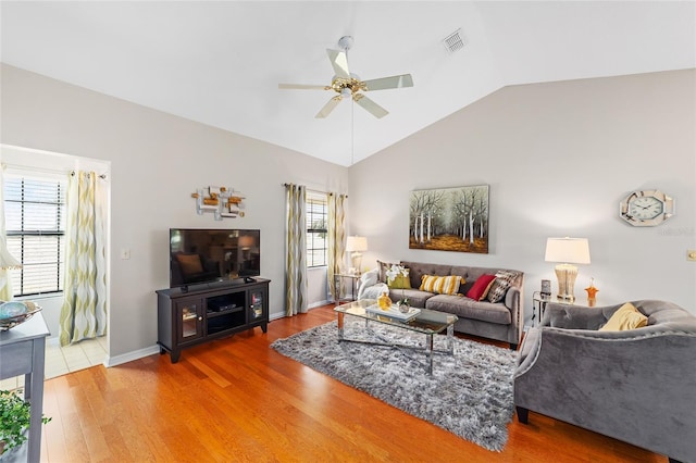 living room featuring hardwood / wood-style flooring, vaulted ceiling, and ceiling fan