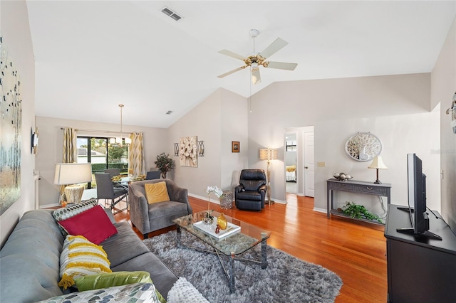 living room with vaulted ceiling, hardwood / wood-style floors, and ceiling fan