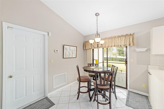 dining space featuring lofted ceiling, a notable chandelier, and light tile patterned flooring