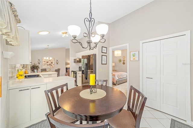 tiled dining room with a chandelier