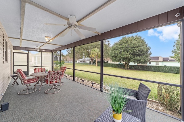 sunroom / solarium featuring plenty of natural light and ceiling fan