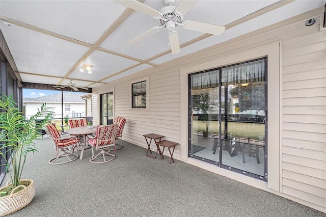 sunroom with coffered ceiling and ceiling fan