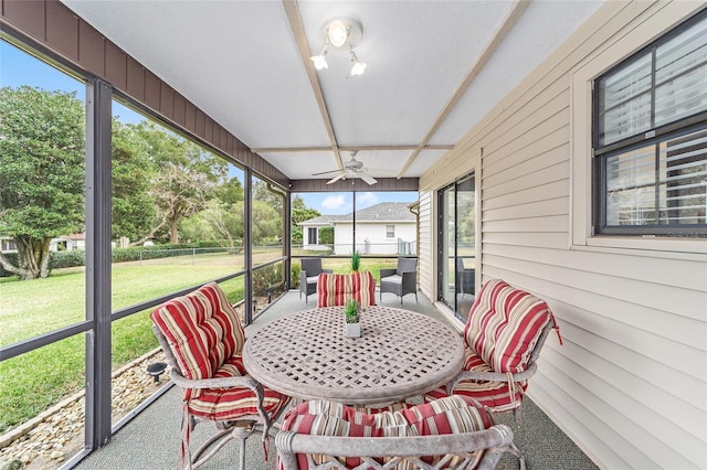 sunroom / solarium featuring ceiling fan and a healthy amount of sunlight