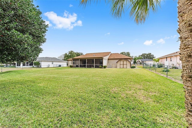 view of yard with a sunroom and a storage shed