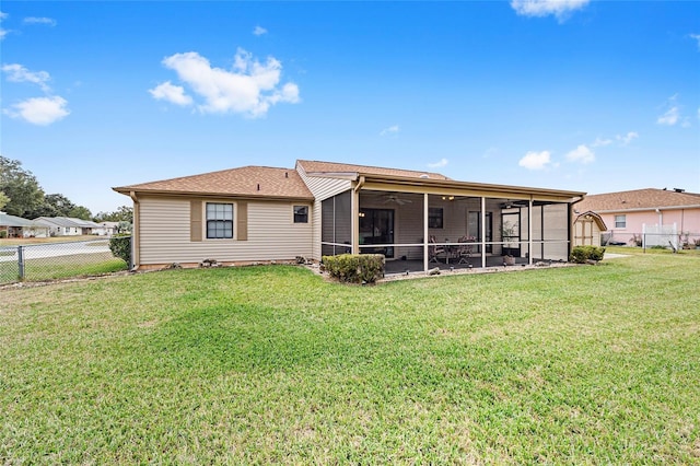 back of property featuring ceiling fan, a yard, and a sunroom