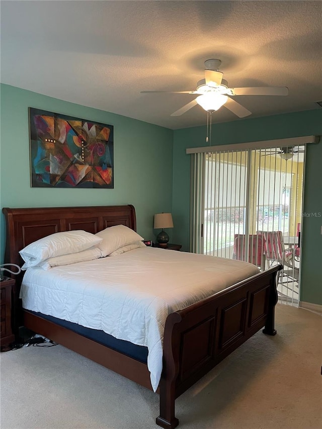 carpeted bedroom with a textured ceiling and ceiling fan