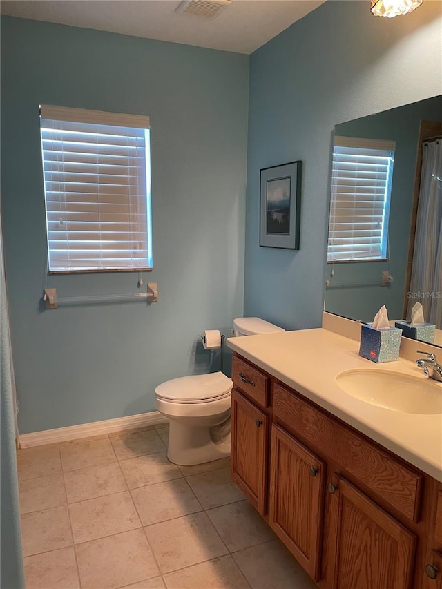 bathroom featuring vanity, toilet, and tile patterned flooring