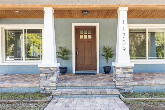 view of exterior entry with a porch