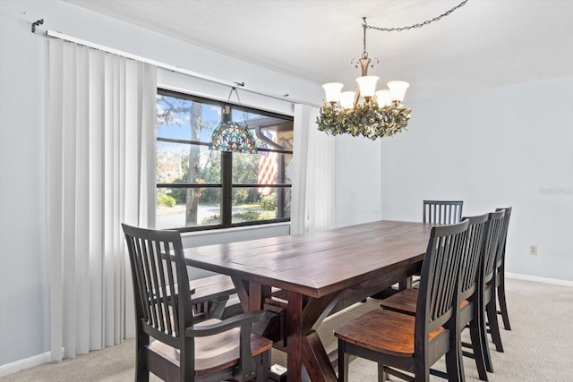 dining area with a notable chandelier and light colored carpet