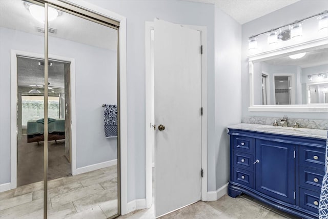 bathroom with vanity and a textured ceiling