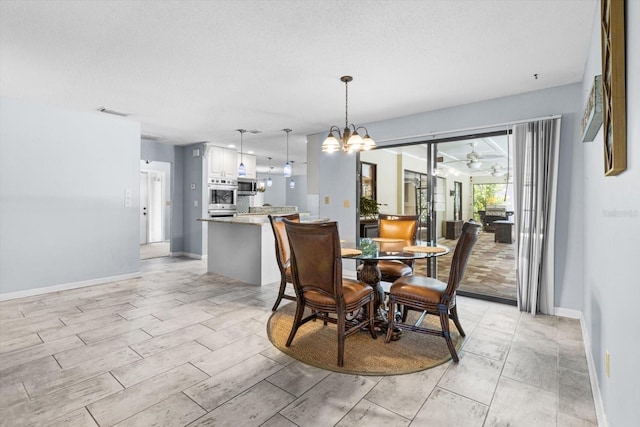 dining area with a notable chandelier and a textured ceiling