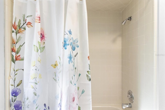 bathroom featuring shower / bathtub combination with curtain