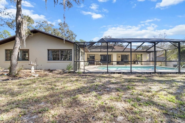 back of property featuring a patio and a lanai