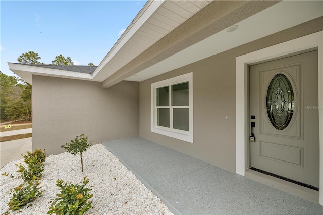 property entrance with a patio area