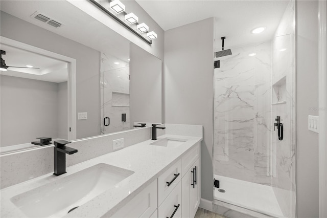 bathroom featuring an enclosed shower, vanity, and ceiling fan