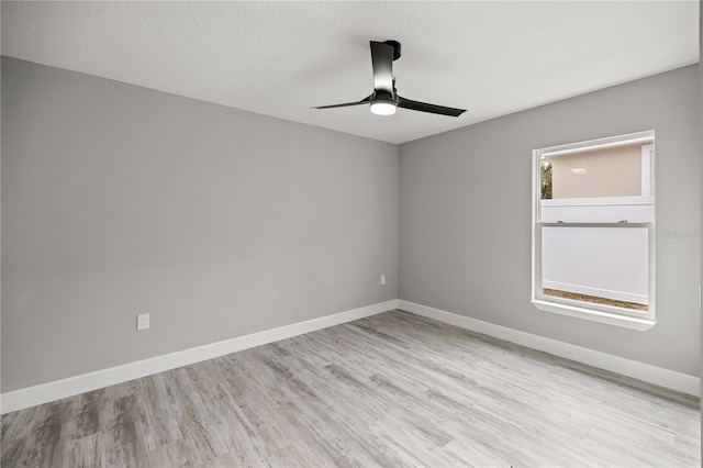 spare room featuring ceiling fan, a textured ceiling, and light wood-type flooring