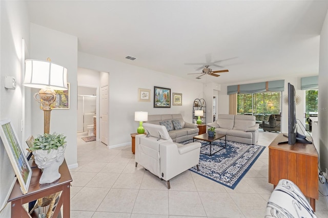 living room featuring ceiling fan, a wall mounted AC, and light tile patterned floors