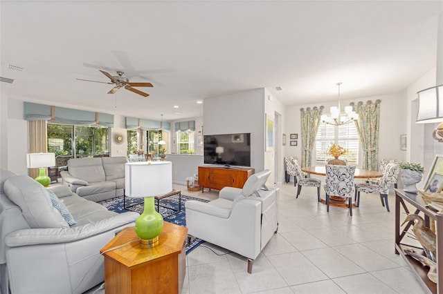 tiled living room featuring ceiling fan with notable chandelier