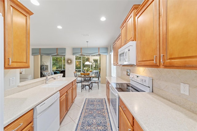 kitchen featuring light tile patterned flooring, sink, pendant lighting, white appliances, and decorative backsplash