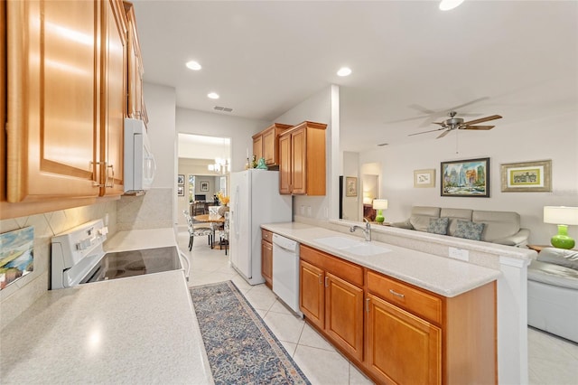 kitchen featuring sink, light tile patterned floors, ceiling fan, white appliances, and backsplash