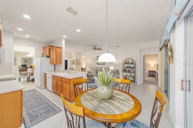 tiled dining area featuring sink and ceiling fan