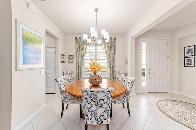 tiled dining space with an inviting chandelier