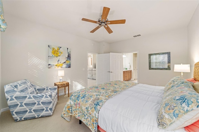 bedroom featuring ensuite bath, ceiling fan, and carpet flooring