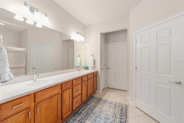 bathroom with vanity, a shower with door, and tile patterned floors