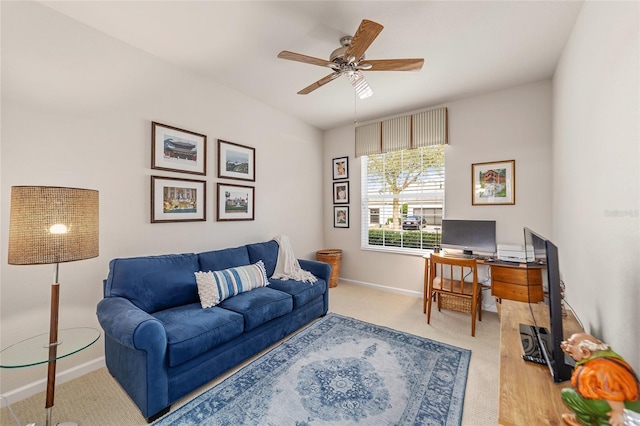 carpeted office space featuring ceiling fan