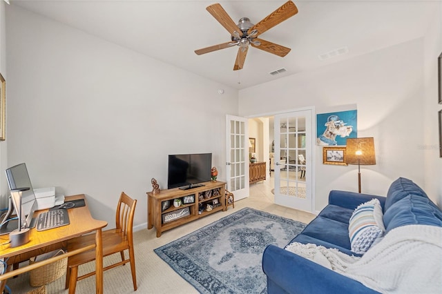 living room featuring french doors, light colored carpet, and ceiling fan