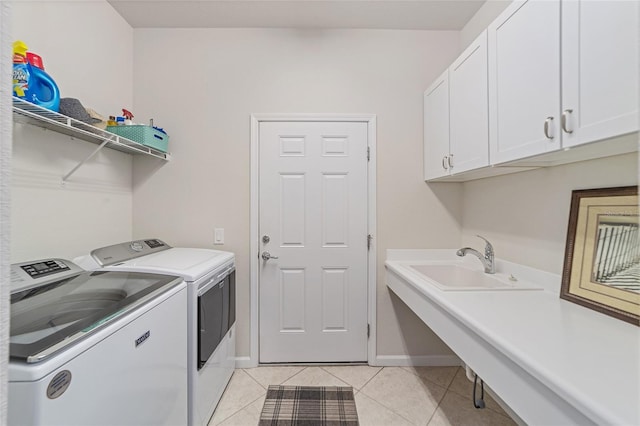 laundry area featuring cabinets, sink, independent washer and dryer, and light tile patterned flooring