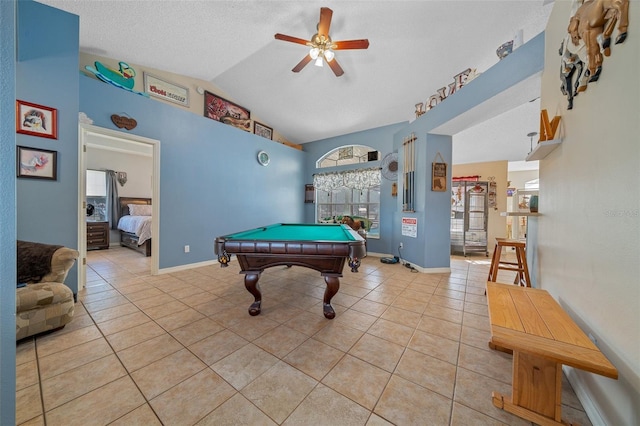 rec room with light tile patterned floors, ceiling fan, a textured ceiling, pool table, and vaulted ceiling