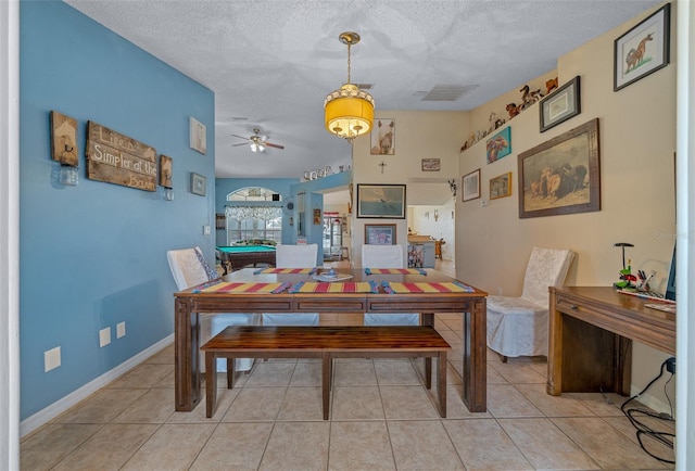 dining room with light tile patterned floors, billiards, and a textured ceiling