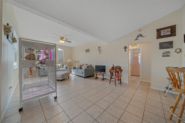 tiled living room with ceiling fan, vaulted ceiling, and a textured ceiling