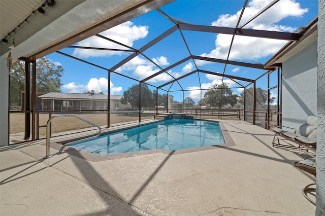 view of pool with a patio and glass enclosure