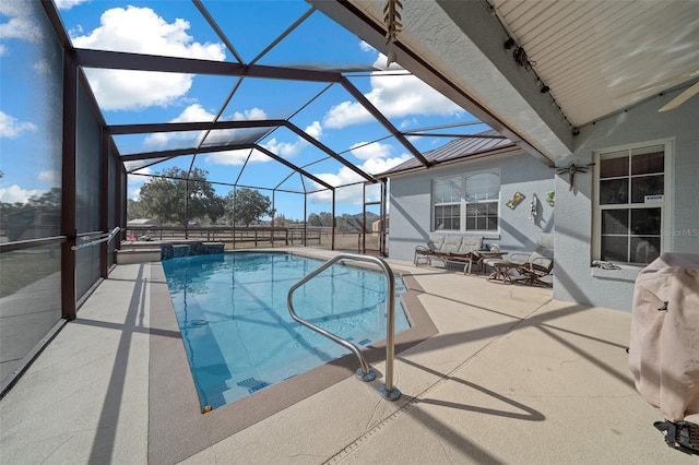 view of swimming pool featuring glass enclosure and a patio area