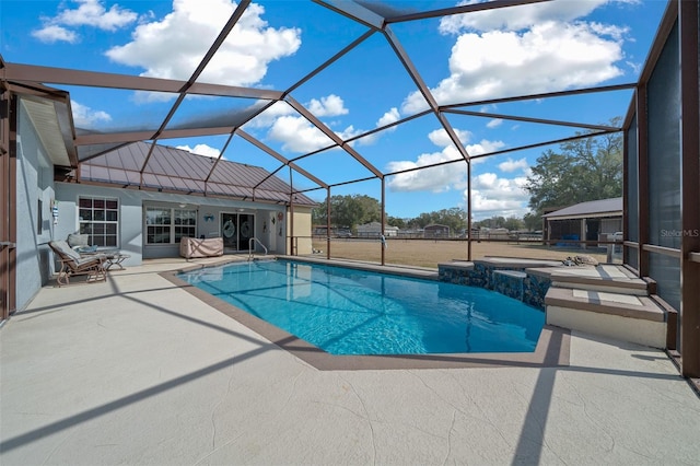 view of pool featuring a lanai, a jacuzzi, and a patio area