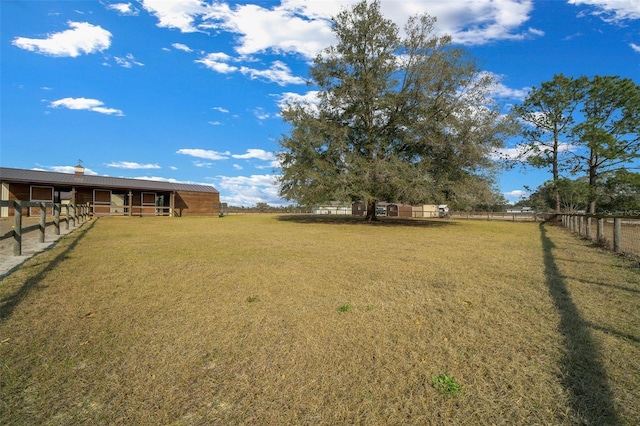 view of yard featuring an outbuilding and a rural view