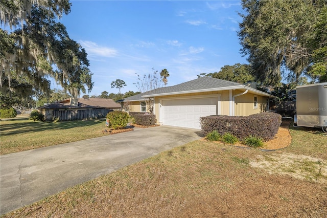 ranch-style home featuring a garage and a front yard