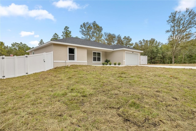 ranch-style house featuring a garage and a front yard