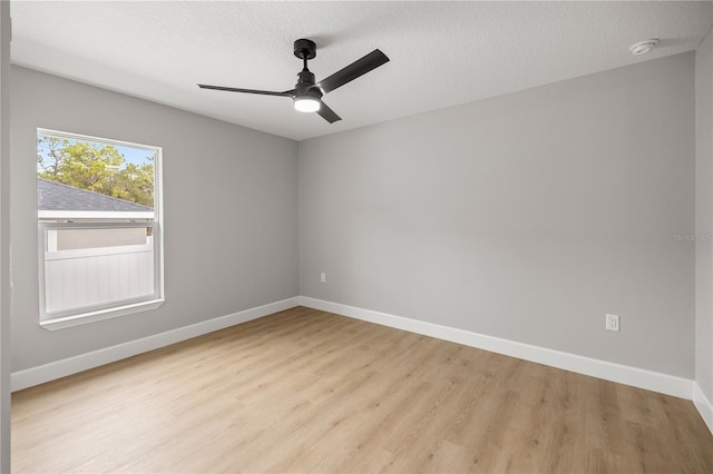 spare room with ceiling fan, a textured ceiling, and light hardwood / wood-style floors