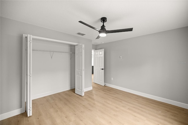 unfurnished bedroom with ceiling fan, a closet, and light hardwood / wood-style flooring