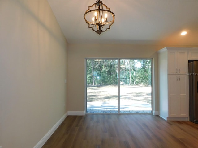 interior space featuring dark hardwood / wood-style floors and an inviting chandelier