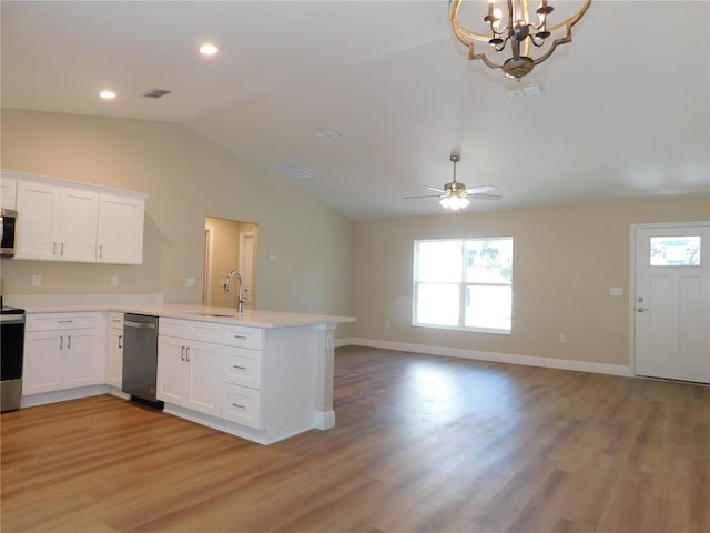 14268 SE 27th Ct, Summerfield, FL 34491 - kitchen with appliances with stainless steel finishes, vaulted ceiling, a peninsula, open floor plan, and light countertops
