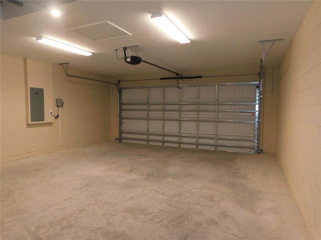 14268 SE 27th Ct, Summerfield, FL 34491 - garage with electric panel, a garage door opener, and concrete block wall