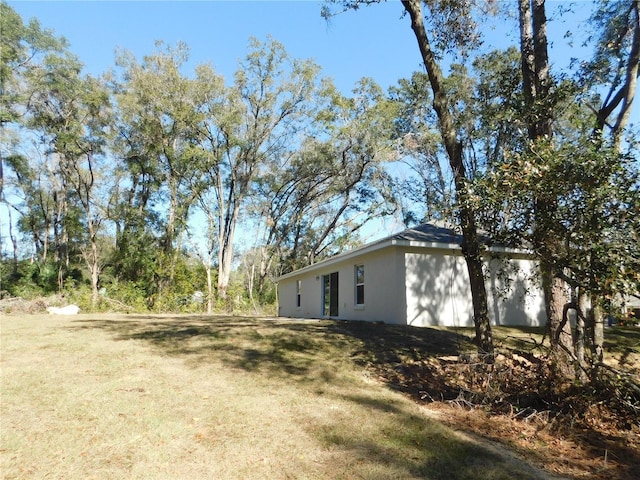 14268 SE 27th Ct, Summerfield, FL 34491 - view of property exterior featuring a lawn